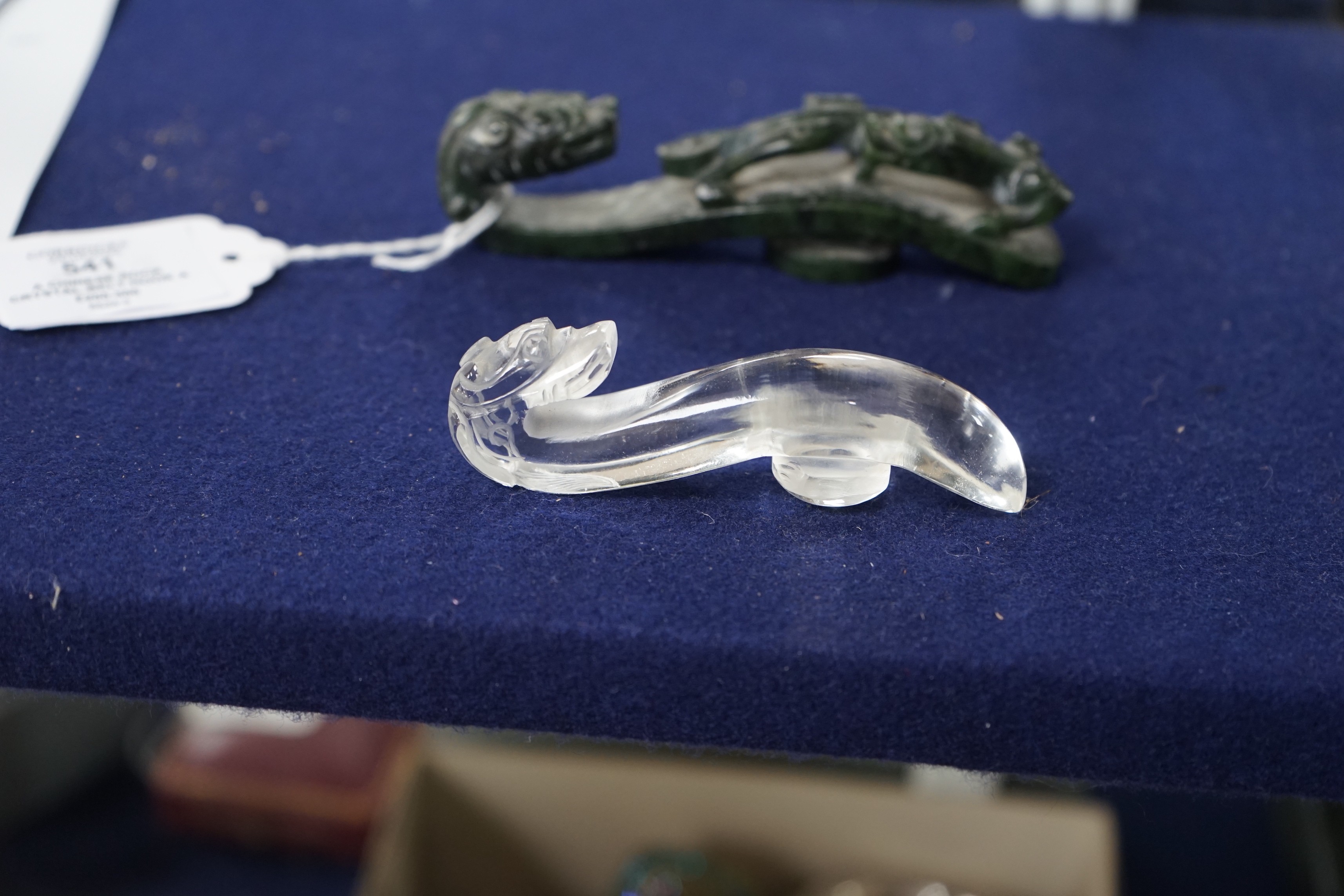 A Chinese rock crystal belt hook and a Chinese spinach green jade belt hook (2), largest 12cms long